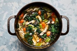 a pot of leftover Turkey Soup with Wild Rice made with carrots, celery, onion, garlic, spices and kale