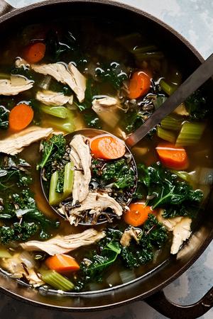 a pot of leftover Turkey Soup with Wild Rice made with carrots, celery, onion, garlic, spices and kale