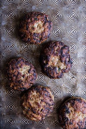 5 ground turkey burger patties on a baking sheet