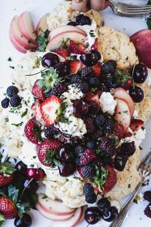 Mixed Berry Shortcake with cherries, strawberries, and whipped cream