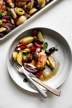 Olive Bar Sheetpan Chicken with onions, peppers, potatoes and garlic on a plate
