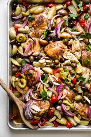 sheet pan chicken dinner made with ingredients found at the olive bar with potatoes.