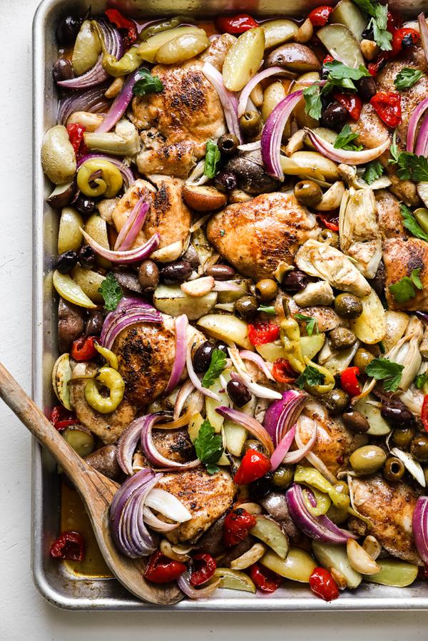 sheet pan chicken dinner made with ingredients found at the olive bar with potatoes.