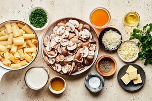 ingredients to make homemade rigatoni with mushroom sauce in bowls on the counter r