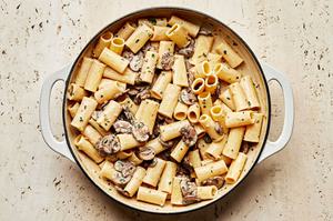 homemade Rigatoni with Mushroom Sauce being pot made with chives, parsley, cream, parmesan, wine and chicken stock