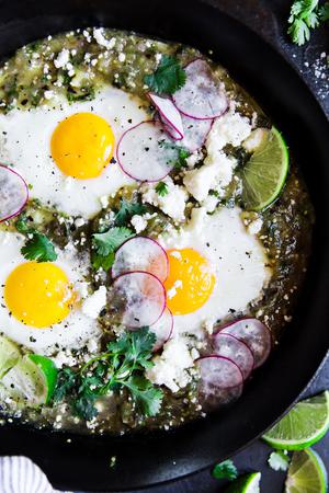 3 eggs baked in salsa verde with radishes and lime and cilantro