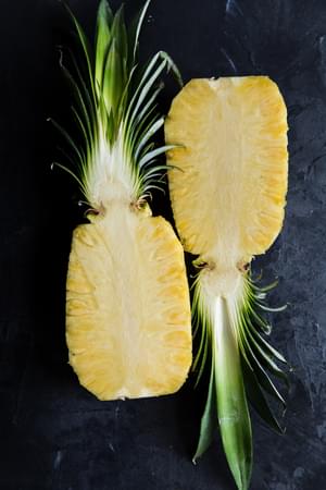 a whole pineapple sliced in half