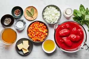 butter, carrots, onion, canned tomatoes, bay leaves, oil, salt, pepper, chicken stock, basil and cream to make tomato bisque