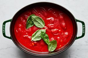 carrots, onion, butter, tomatoes, bay leaves, olive oil, salt, pepper, and chicken stock in a pot for tomato bisque