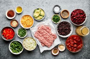 ground turkey, bell peppers, onion, jalapeno, spices, kidney & black beans, tomatoes and chicken stock in prep bowls