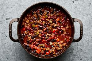 a pot of homemade turkey chili made with bell peppers, onion, jalapeno, spices, kidney & black beans, tomatoes and stock