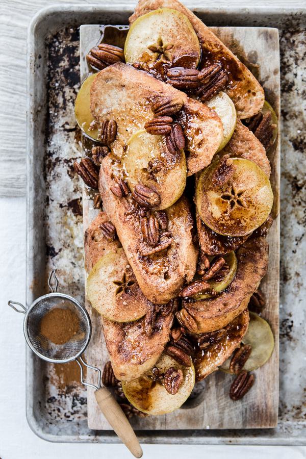 Apple Pecan French Toast with cinnamon and pecans on a baking sheet
