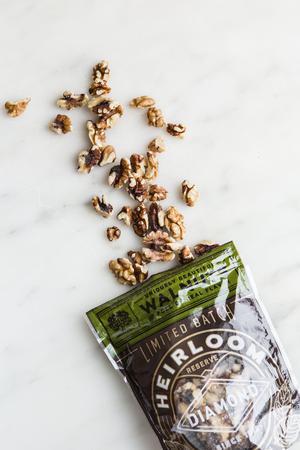 a bag with walnuts spilling out of it on a counter