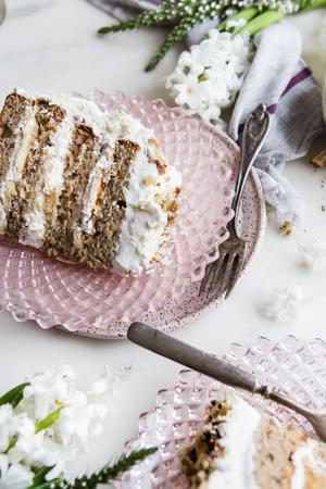 banana walnut cake on a cake stand with two slices on plates