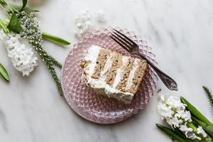 banana walnut cake on a cake stand with two slices on plates
