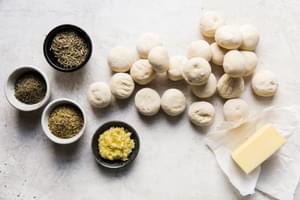 20 thaw, raise and baked frozen dinner rolls, 1 cup of salted butter, minced garlic and dried herbs