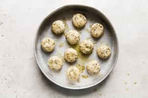frozen rhodes dinner rolls in butter and herbs in a pan