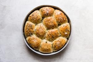 golden brown rhodes dinner rolls fresh out of the oven with garlic, herb butter.
