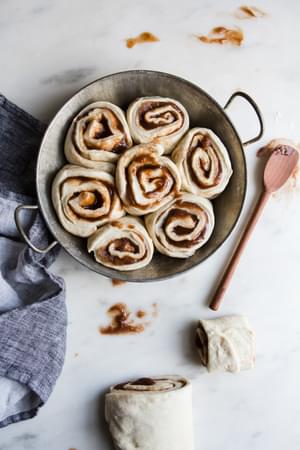 vegan cinnamon rolls in a pan getting ready to be baked