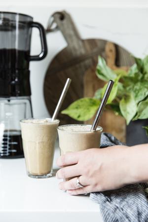 hand reaching for an iced bullet proof coffee