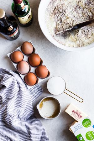 ingredients laid out for bundt cake recipe, butter, flour, eggs, irish cream