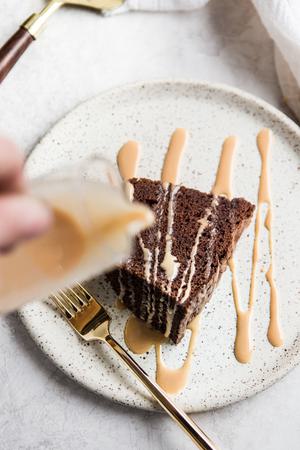 a slice of Chocolate Bundt Cake with an icing drizzle on a plate