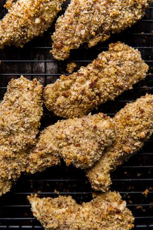 crispy Baked chicken tenderloins on a baking rack close up