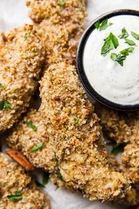 Pecan Crusted Chicken Tenders with buttermilk ranch in a small bowl