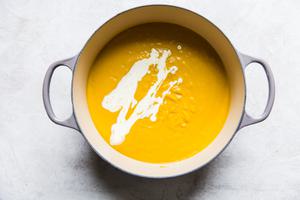 purred Roasted Butternut Squash Soup With Apples in a soup pot with cream