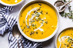 Roasted Butternut Squash Soup With Apples in a bowl garnished with pumpkin seeds