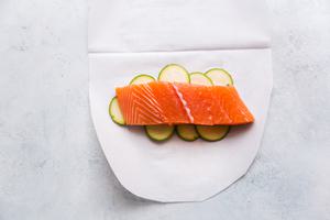 zucchini, fennel and salmon on parchment paper for en papillote