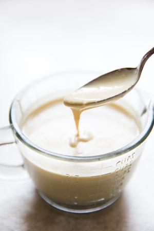 tahini sauce in a small bowl with a spoon