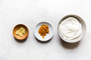 curry aioli ingredients in three bowls. garlic, curry and mayonnaise.