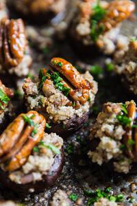 Close up of Goat Cheese And Pecan Stuffed Mushrooms on a baking sheet