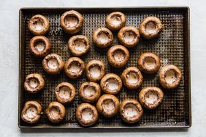 mushroom caps on a baking sheet