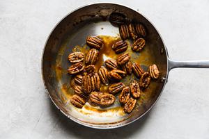 seasoned pecans sautéed in a pan