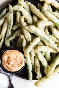 tempura green beans with curry mayonnaise on a platter