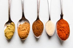 cumin, chili powder, garlic powder, cinnamon, smoked paprika on spoons