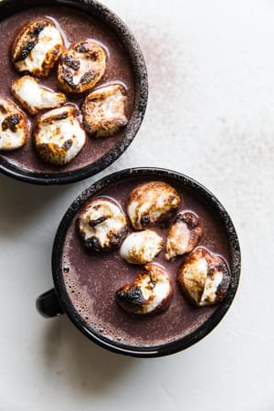 two cups of homemade alcoholic hot chocolate topped with marshmallows