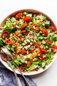 Asian Chopped Salad in a large bowl with serving spoons