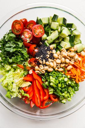 chopped ingredients for Asian Chopped salad in a large glass bowl