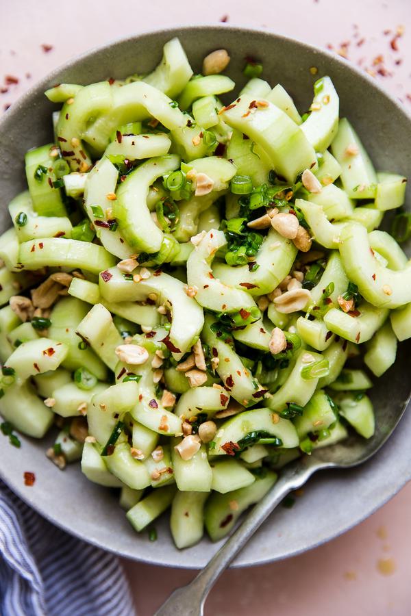 asian cucumber salad in a large bowl with a spoon