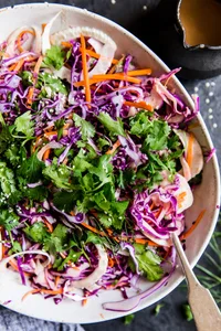 Asian Slaw With Sriracha Dressing in a bowl with a spoon