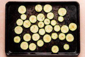 sliced raw seasoned zucchini ready to be roasted to perfection