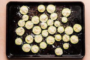sliced raw zucchini seasoned with salt, pepper and garlic powder topped with grated parmesan cheese