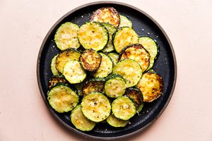 a plate of crispy, golden delicious roasted zucchini with parmesan