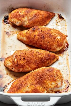 baked chicken in a casserole dish seasoned with salt, pepper, garlic powder, onion powder, paprika & brown sugar