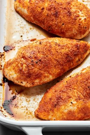 baked chicken in a casserole dish seasoned with salt, pepper, garlic powder, onion powder, paprika & brown sugar