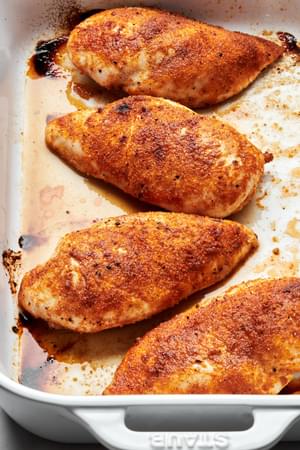 baked chicken in a casserole dish seasoned with salt, pepper, garlic powder, onion powder, paprika & brown sugar