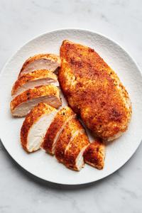 baked chicken sliced on a plate seasoned with salt, pepper, garlic powder, onion powder, paprika & brown sugar